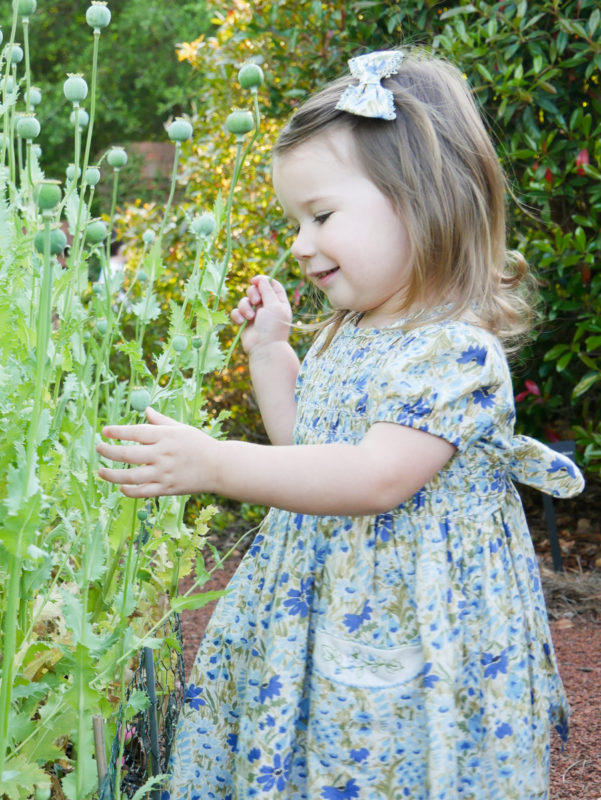 girl standing in flower garden