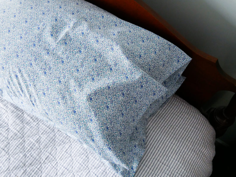 blue floral pillowcases on bed