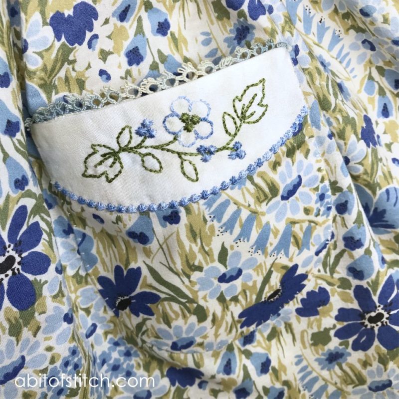 close up of pocket with flowers on dress 